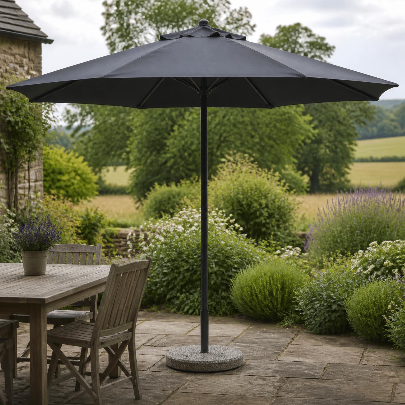 Corsham 3m garden parasol in charcoal grey, open on a stone patio
