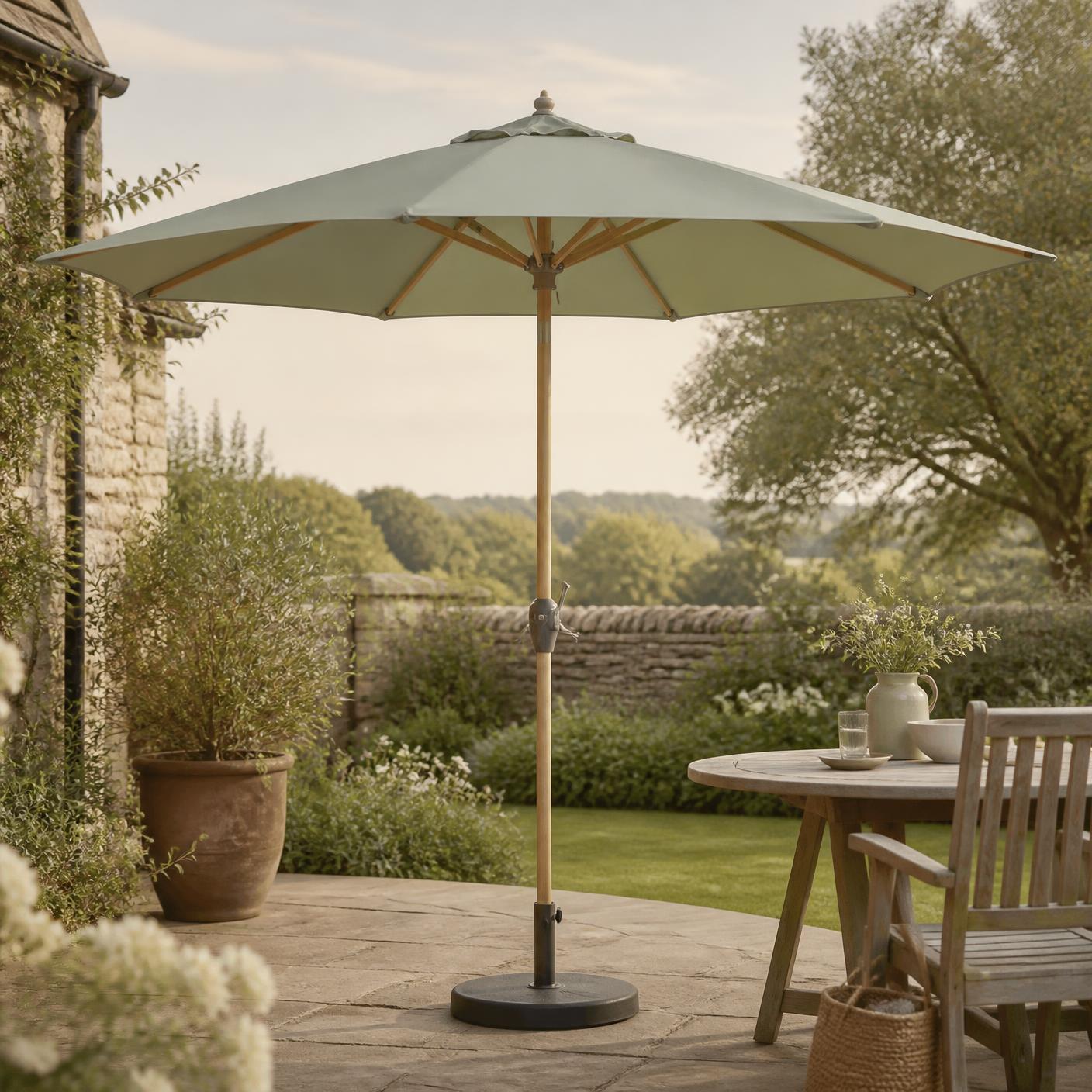 Corsham 3m garden parasol in sage green, open on a stone patio